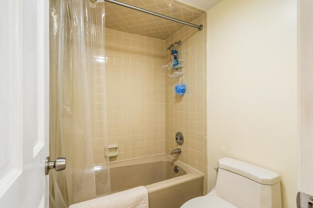 bathroom featuring toilet and shower / bath combo with shower curtain