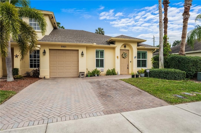 view of front of property with a garage and a front yard