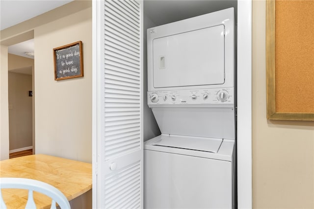 laundry area with stacked washing maching and dryer