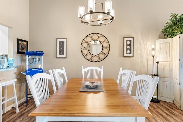 dining room featuring hardwood / wood-style flooring and a chandelier