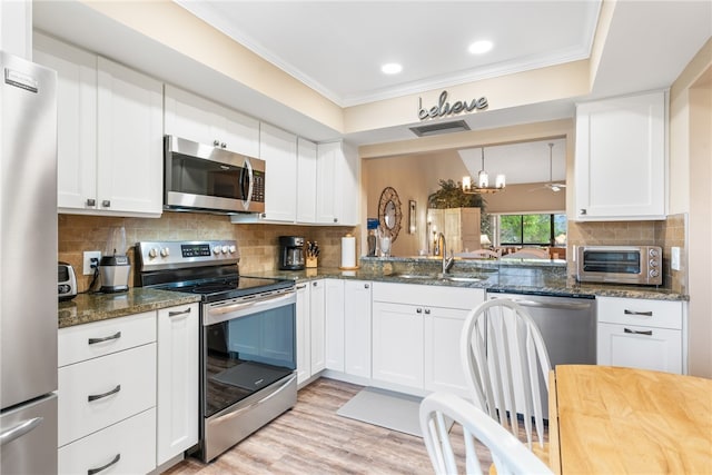 kitchen featuring white cabinetry, sink, light wood-type flooring, and appliances with stainless steel finishes