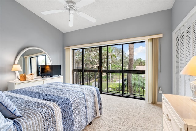 carpeted bedroom featuring access to exterior, multiple windows, ceiling fan, and a closet