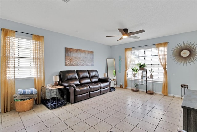 tiled living room featuring ceiling fan and a textured ceiling