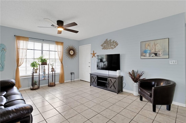 tiled living room featuring a textured ceiling and ceiling fan