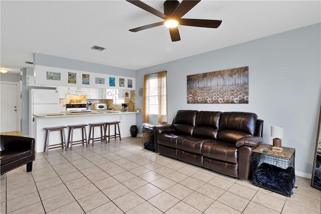 tiled living room with ceiling fan