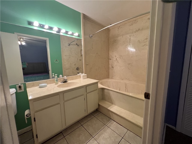 bathroom with ceiling fan, vanity, tile patterned flooring, and  shower combination