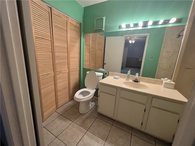 bathroom featuring vanity, ceiling fan, tile patterned flooring, and toilet