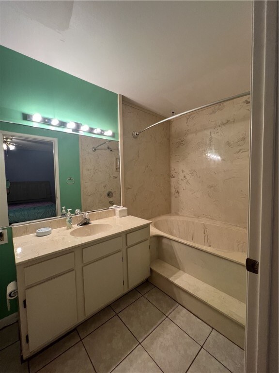 bathroom featuring vanity, tile patterned floors, and tiled shower / bath combo