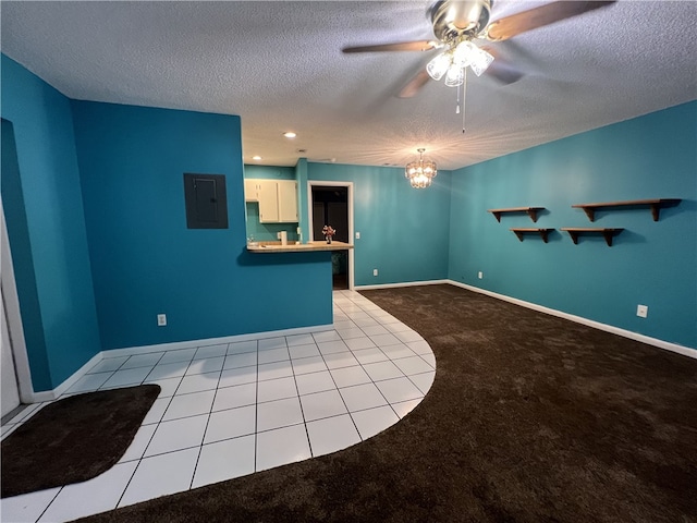 unfurnished living room featuring electric panel, ceiling fan with notable chandelier, a textured ceiling, and light carpet