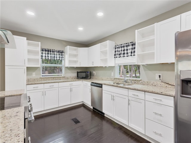 kitchen with white cabinets, appliances with stainless steel finishes, and light stone countertops