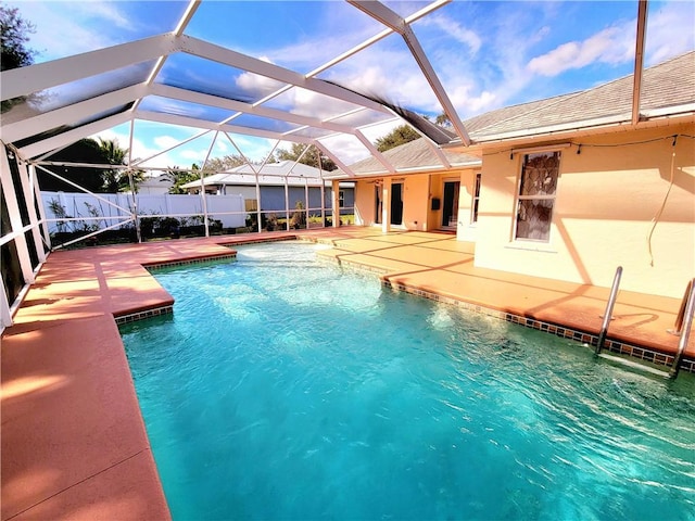 view of swimming pool with a patio and glass enclosure