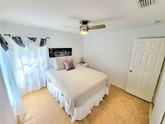 bedroom with light tile patterned floors and ceiling fan