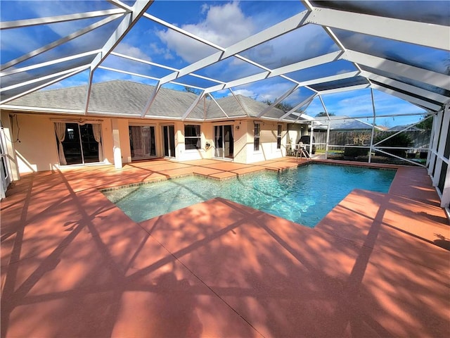 view of swimming pool with a lanai and a patio area