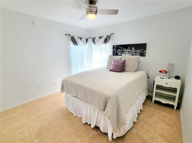 tiled bedroom featuring ceiling fan