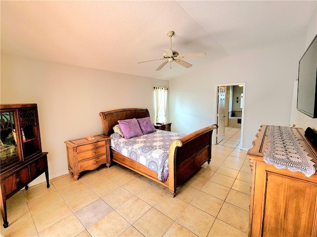 tiled bedroom featuring ceiling fan, lofted ceiling, and ensuite bathroom