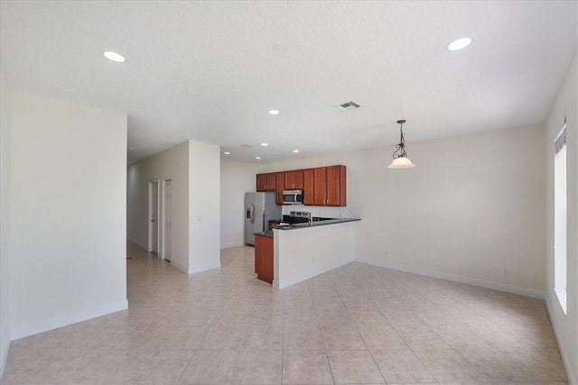 263 Provence Pl, Vero Beach, FL 32960 - kitchen with stainless steel appliances, open floor plan, dark countertops, a peninsula, and recessed lighting
