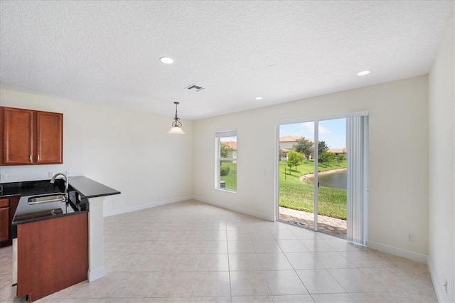 263 Provence Pl, Vero Beach, FL 32960 - unfurnished living room with a textured ceiling, recessed lighting, and light tile patterned floors