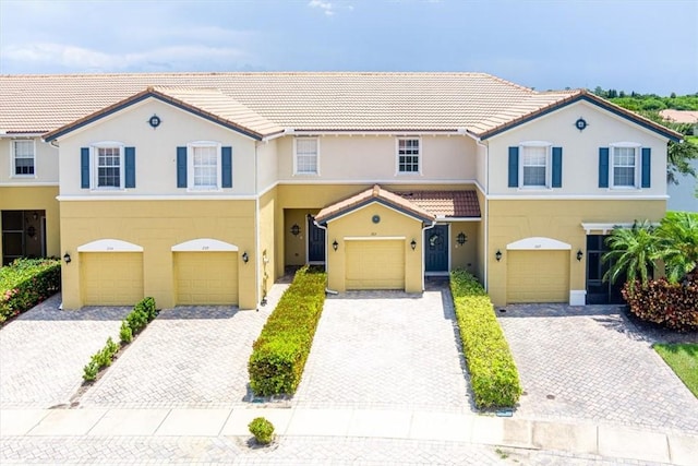 263 Provence Pl, Vero Beach, FL 32960 - multi unit property with an attached garage, driveway, stucco siding, and a tile roof