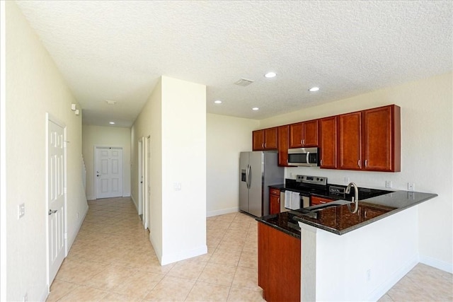 263 Provence Pl, Vero Beach, FL 32960 - kitchen featuring stainless steel appliances, recessed lighting, a peninsula, a textured ceiling, and light tile patterned flooring