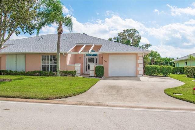 ranch-style home featuring driveway, a garage, a front lawn, and stucco siding