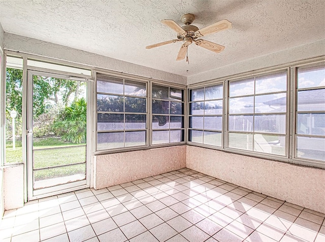 unfurnished sunroom featuring ceiling fan