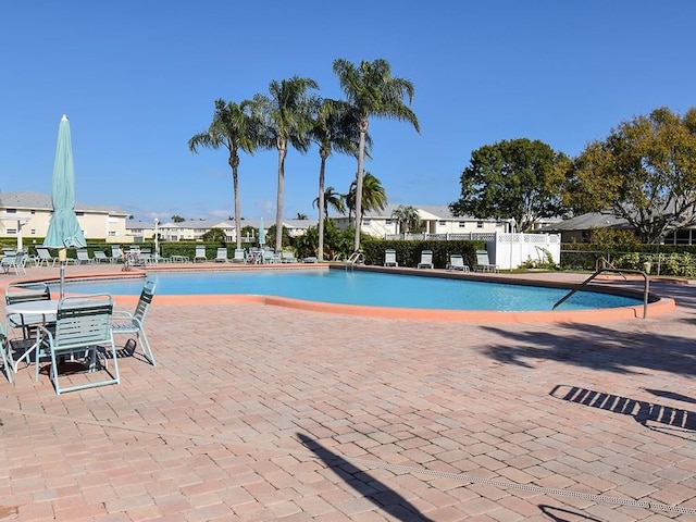 pool featuring fence and a patio