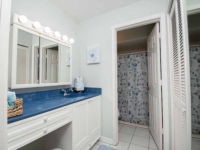 bathroom with tile patterned flooring, vanity, and a shower with curtain