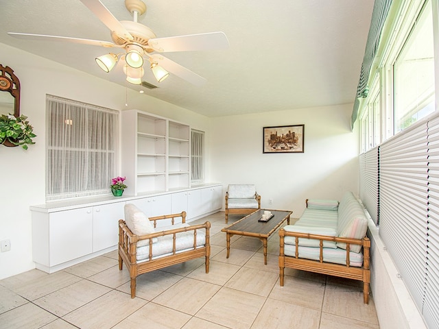 living area featuring light tile patterned flooring and a ceiling fan