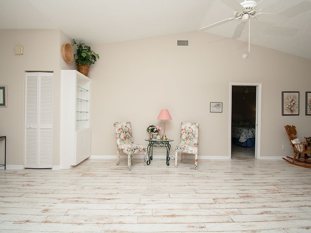 sitting room featuring visible vents, ceiling fan, vaulted ceiling, wood finished floors, and baseboards