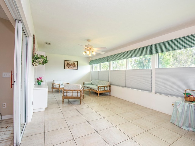 sunroom with ceiling fan and visible vents