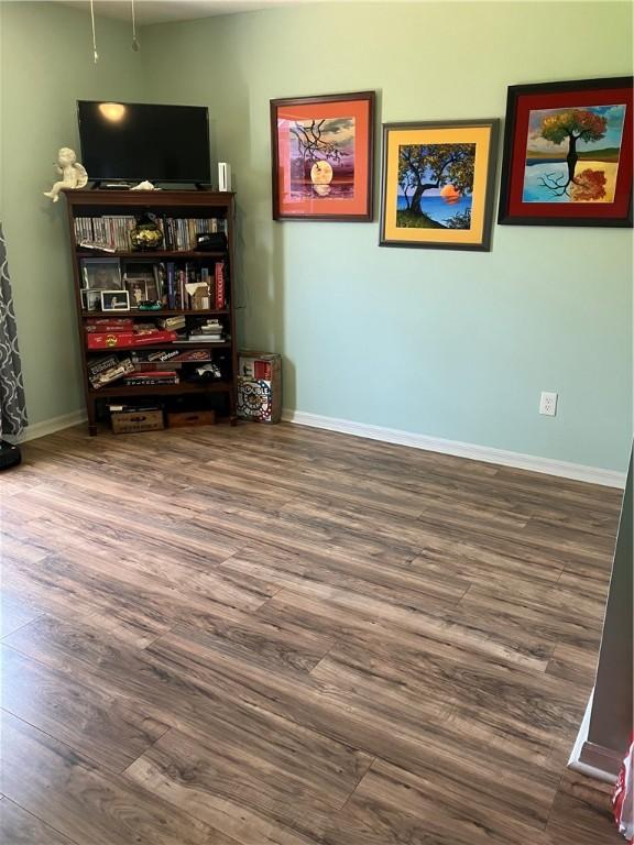 interior space featuring baseboards and wood finished floors