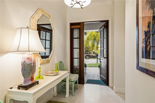 entryway featuring light tile patterned floors and crown molding