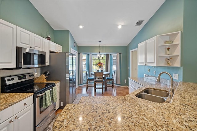 kitchen with visible vents, a sink, white cabinets, stainless steel appliances, and open shelves