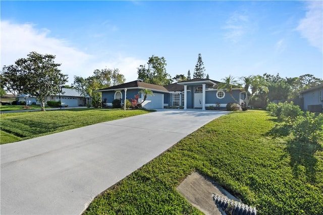 single story home featuring concrete driveway and a front yard