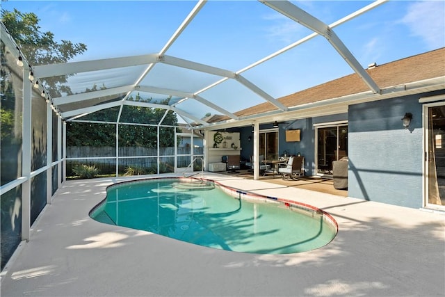 view of swimming pool with a fenced in pool, fence, a lanai, and a patio area