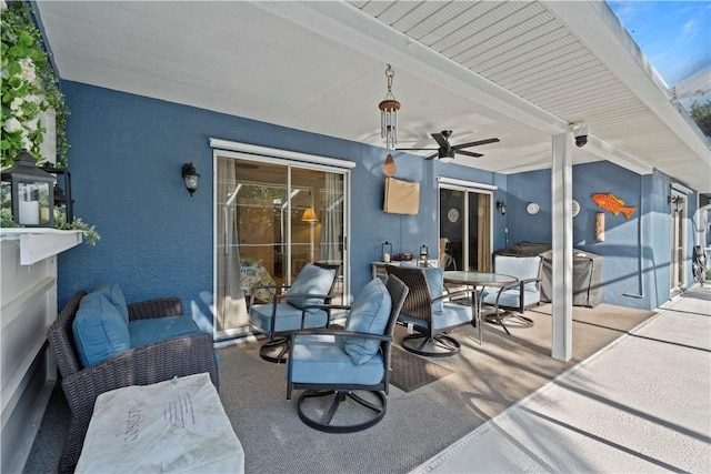 view of patio / terrace with an outdoor hangout area, outdoor dining space, and a ceiling fan