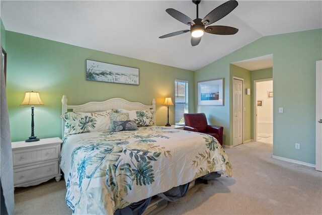 carpeted bedroom with a ceiling fan, lofted ceiling, baseboards, and a closet