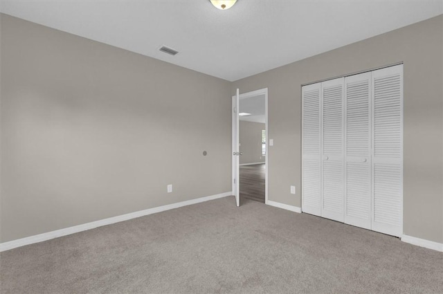 unfurnished bedroom featuring carpet floors and a closet