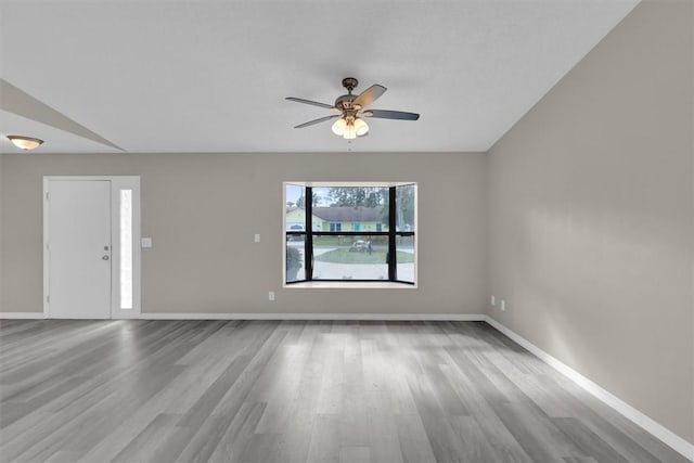 spare room featuring light wood-type flooring and ceiling fan