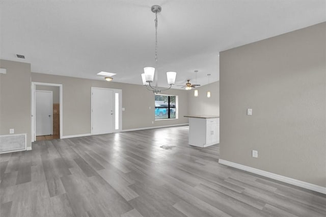 unfurnished living room featuring light hardwood / wood-style flooring and ceiling fan with notable chandelier