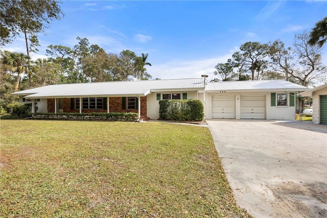 ranch-style house featuring a front yard and a garage