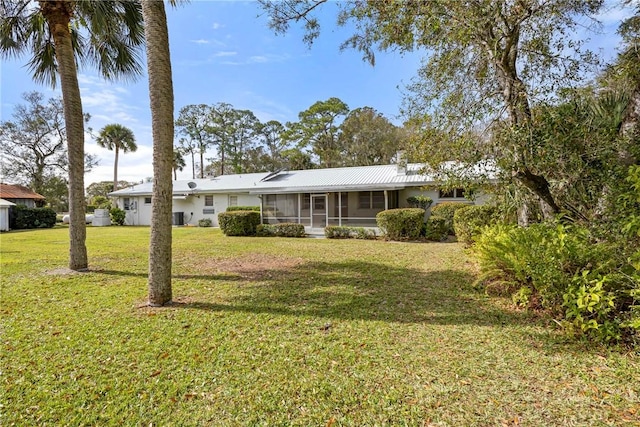 ranch-style house with a front yard and a sunroom