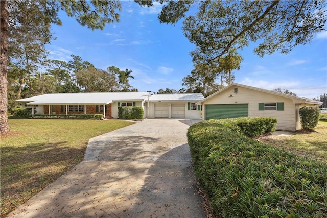 single story home featuring a front lawn and a garage