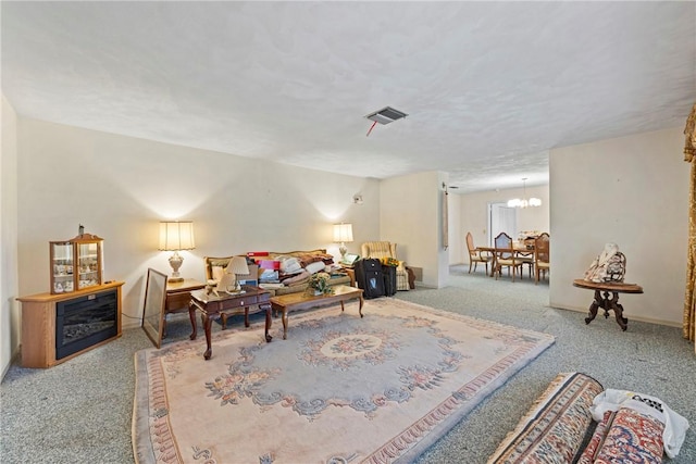 living room featuring an inviting chandelier and carpet flooring