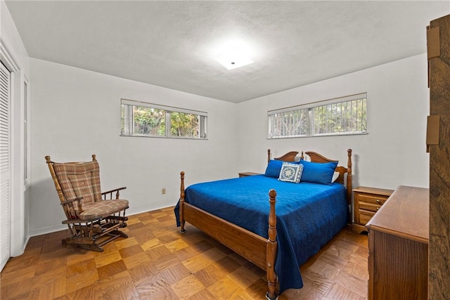 bedroom featuring light parquet flooring