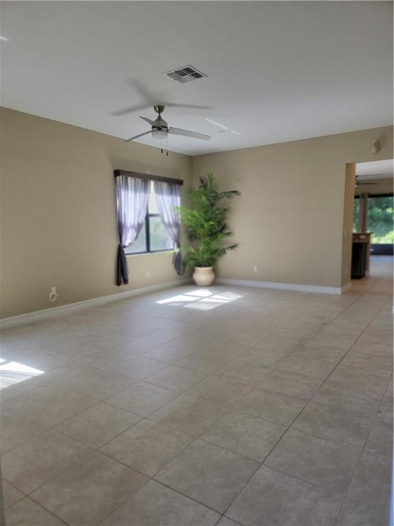 4295 55th St, Vero Beach, FL 32967 - unfurnished room featuring plenty of natural light, ceiling fan, baseboards, and light tile patterned floors