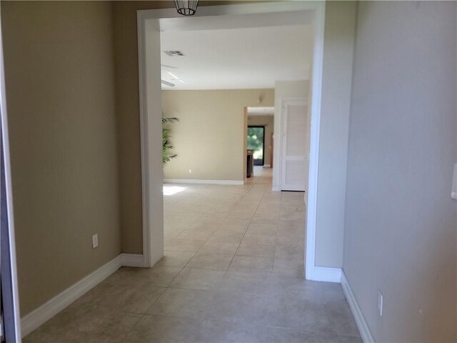 4295 55th St, Vero Beach, FL 32967 - hallway featuring light tile patterned floors and baseboards