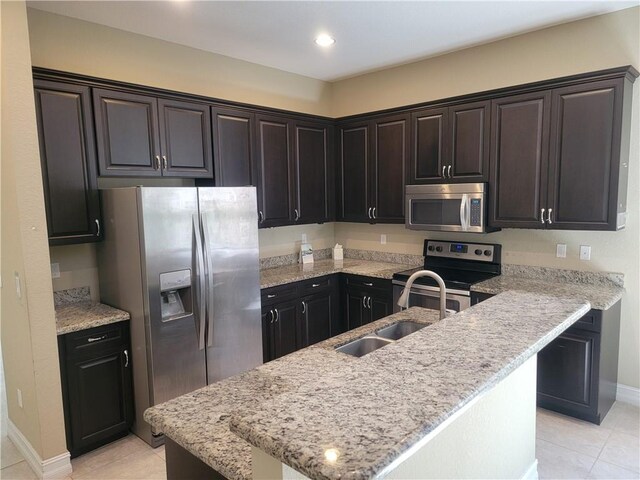 4295 55th St, Vero Beach, FL 32967 - kitchen featuring appliances with stainless steel finishes, a sink, light tile patterned flooring, baseboards, and recessed lighting