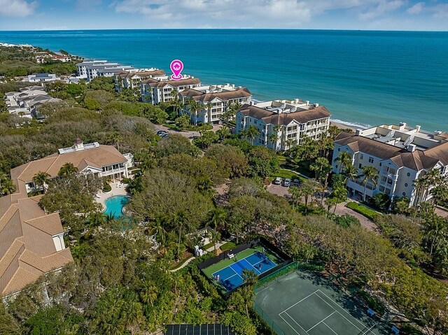 drone / aerial view featuring a water view and a beach view