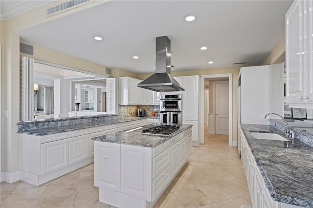 kitchen featuring white cabinets, appliances with stainless steel finishes, sink, and island exhaust hood